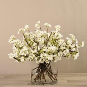 أغصان أزهار صناعية في مزهرية زجاجية